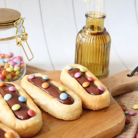 Finger biscuits coated in chocolate and multicolored chocolate beads